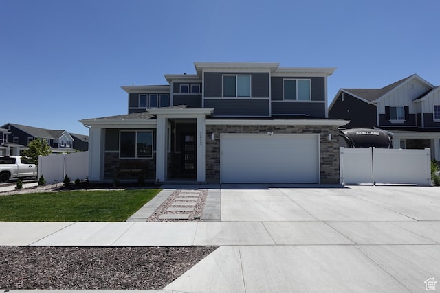 2323 W Thomas Ct, Syracuse, UT 84075 - prairie-style house with driveway, an attached garage, and stone siding