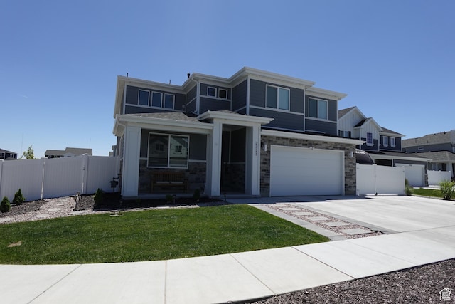 2323 W Thomas Ct, Syracuse, UT 84075 - view of front of house featuring a garage, driveway, stone siding, and a porch