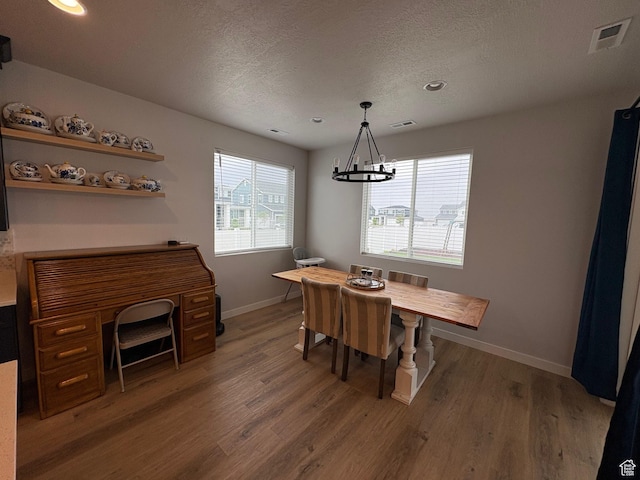 2323 W Thomas Ct, Syracuse, UT 84075 - dining space with a chandelier, wood finished floors, baseboards, a textured ceiling, and recessed lighting