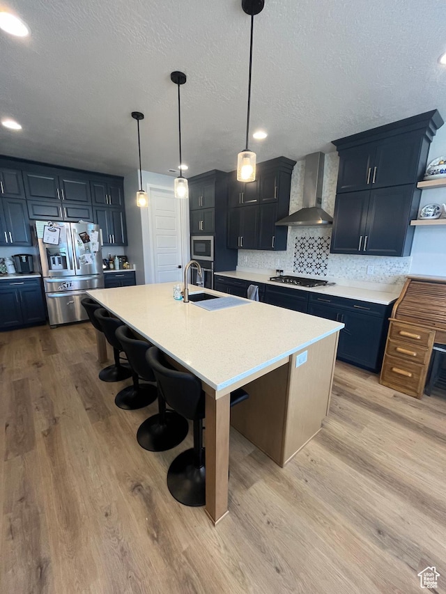 2323 W Thomas Ct, Syracuse, UT 84075 - kitchen featuring wall chimney exhaust hood, gas stovetop, light countertops, a kitchen bar, and open shelves