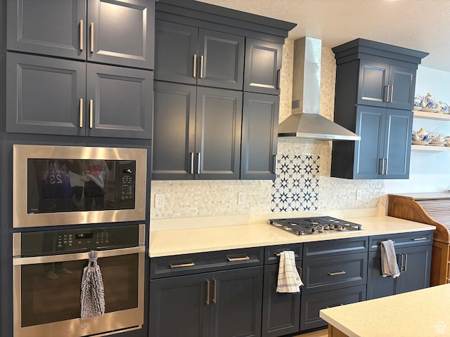 2323 W Thomas Ct, Syracuse, UT 84075 - kitchen with stainless steel appliances, wall chimney range hood, light countertops, backsplash, and open shelves