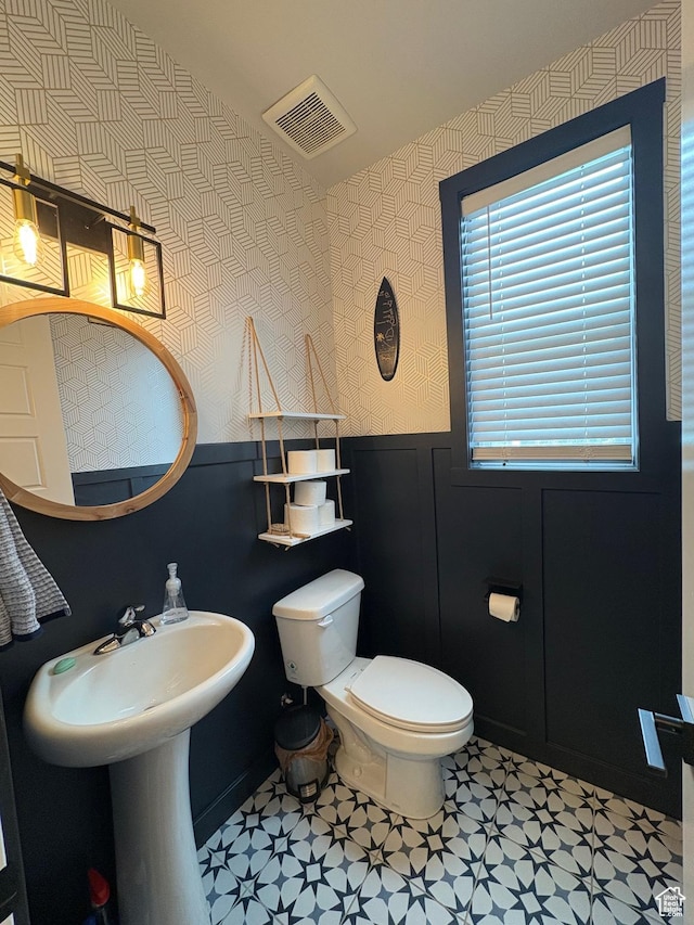2323 W Thomas Ct, Syracuse, UT 84075 - bathroom featuring wallpapered walls, a wainscoted wall, toilet, and tile patterned floors