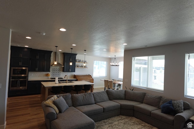 2323 W Thomas Ct, Syracuse, UT 84075 - living room with recessed lighting, a chandelier, dark wood finished floors, and a textured ceiling