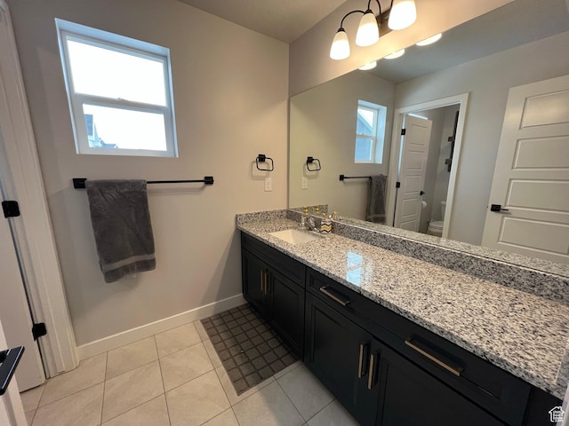 2323 W Thomas Ct, Syracuse, UT 84075 - bathroom with baseboards, vanity, healthy amount of natural light, and toilet