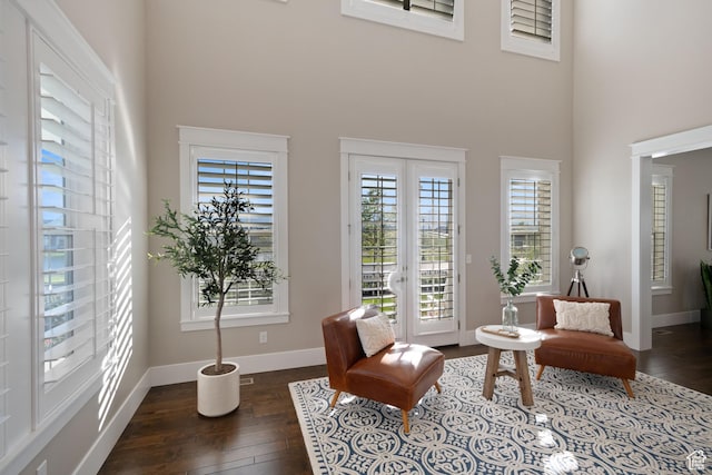 4492 W Enid Dr, South Jordan, UT 84009 - living area with wood-type flooring, a towering ceiling, and baseboards