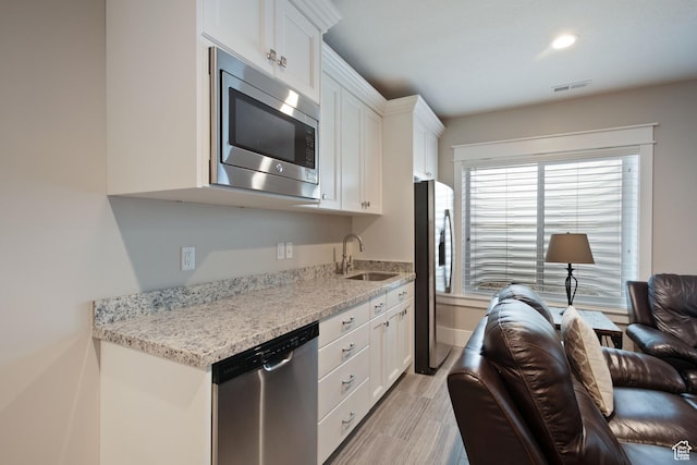 4492 W Enid Dr, South Jordan, UT 84009 - kitchen with appliances with stainless steel finishes, a sink, white cabinetry, and recessed lighting