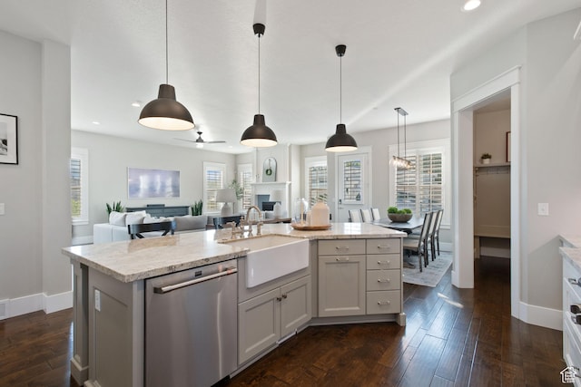 4492 W Enid Dr, South Jordan, UT 84009 - kitchen with stainless steel dishwasher, a sink, open floor plan, a fireplace, and baseboards