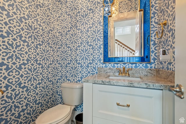 4492 W Enid Dr, South Jordan, UT 84009 - bathroom featuring toilet, wallpapered walls, and vanity