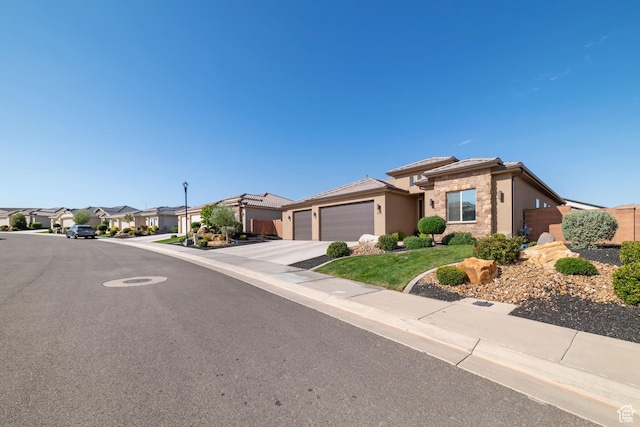 478 S Albano Way, St George, UT 84770 - view of front of property featuring stone siding, a garage, stucco siding, a residential view, and driveway