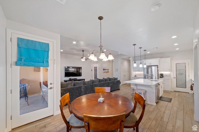 478 S Albano Way, St George, UT 84770 - dining room with light wood-style floors, a chandelier, a ceiling fan, and recessed lighting