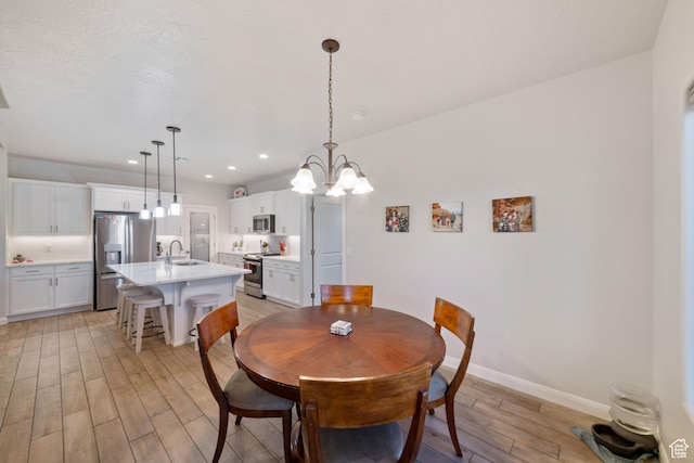 478 S Albano Way, St George, UT 84770 - dining space featuring light wood finished floors, baseboards, recessed lighting, and a chandelier