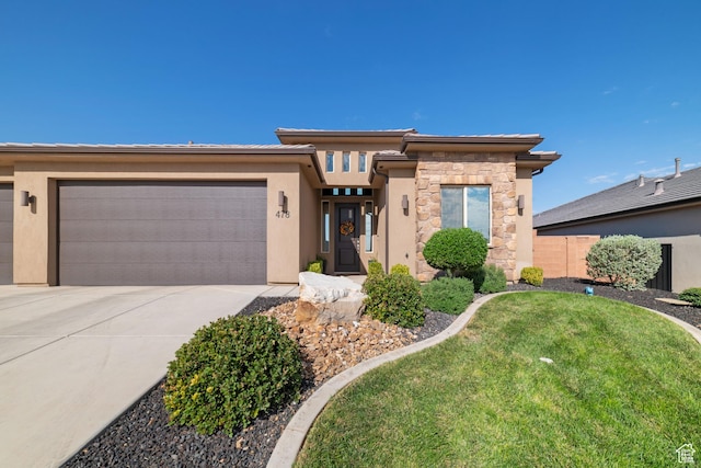 478 S Albano Way, St George, UT 84770 - prairie-style home with an attached garage, driveway, stone siding, and stucco siding