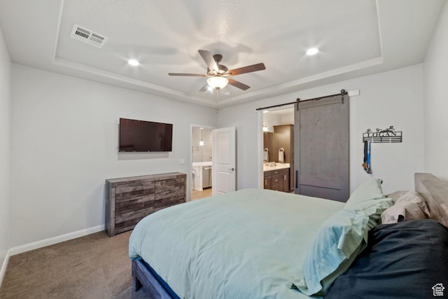 478 S Albano Way, St George, UT 84770 - bedroom with a barn door, a tray ceiling, baseboards, connected bathroom, and light colored carpet
