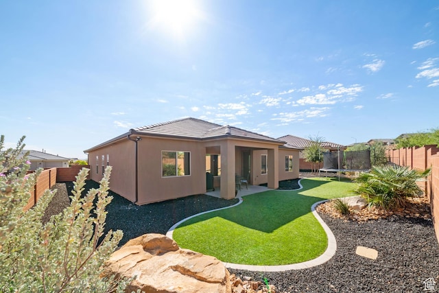 478 S Albano Way, St George, UT 84770 - rear view of property featuring a trampoline, a tiled roof, a patio area, and stucco siding