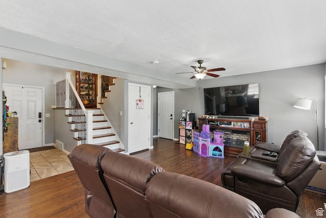 122 W Stern Ct Unit 25, Stansbury Park, UT 84074 - living room featuring stairway, ceiling fan, wood finished floors, and baseboards