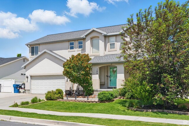 122 W Stern Ct Unit 25, Stansbury Park, UT 84074 - traditional-style house with stucco siding, concrete driveway, and a garage