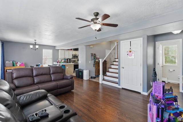 122 W Stern Ct Unit 25, Stansbury Park, UT 84074 - living area with stairs, a ceiling fan, a chandelier, dark wood-style flooring, and a textured ceiling