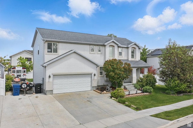 122 W Stern Ct Unit 25, Stansbury Park, UT 84074 - traditional home featuring an attached garage, a front lawn, stucco siding, concrete driveway, and a shingled roof