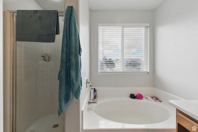 122 W Stern Ct Unit 25, Stansbury Park, UT 84074 - bathroom featuring vanity, a bath, and a stall shower