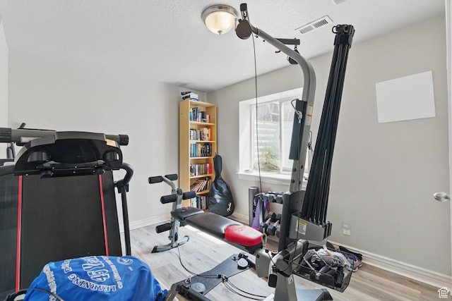 122 W Stern Ct Unit 25, Stansbury Park, UT 84074 - workout room with wood finished floors, baseboards, and a textured ceiling