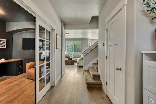 10966 S Coastal Dune Dr, South Jordan, UT 84009 - corridor with wood finished floors, stairway, and french doors