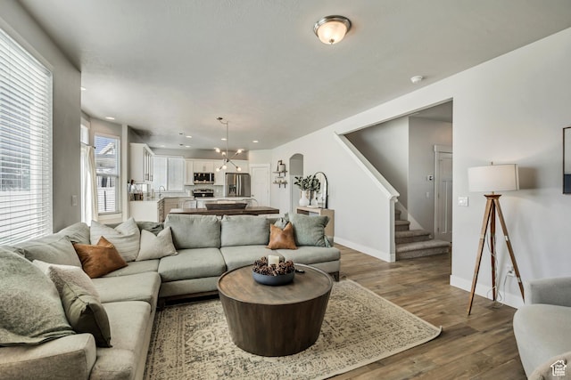 10966 S Coastal Dune Dr, South Jordan, UT 84009 - living area with arched walkways, stairs, wood finished floors, baseboards, and recessed lighting