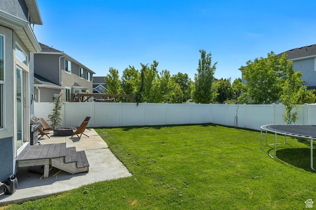 10966 S Coastal Dune Dr, South Jordan, UT 84009 - view of yard with a trampoline, a patio, and a fire pit