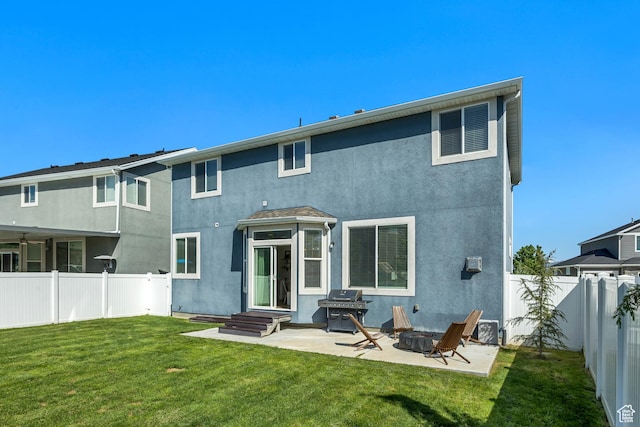 10966 S Coastal Dune Dr, South Jordan, UT 84009 - back of house with stucco siding, a patio area, and an outdoor fire pit