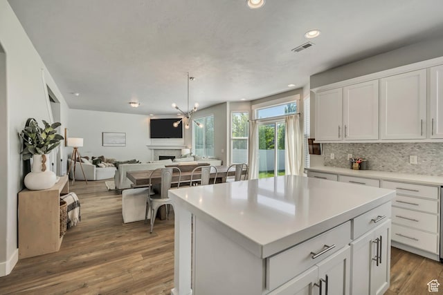 10966 S Coastal Dune Dr, South Jordan, UT 84009 - kitchen featuring white cabinetry, decorative backsplash, open floor plan, wood finished floors, and recessed lighting