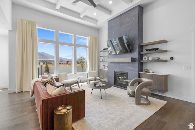 2041 W Pinnacle Ave, Mapleton, UT 84664 - living area with dark wood-style flooring, beam ceiling, a tile fireplace, coffered ceiling, and recessed lighting