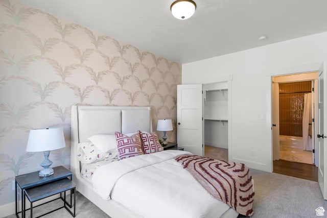 2041 W Pinnacle Ave, Mapleton, UT 84664 - bedroom with carpet flooring, wallpapered walls, baseboards, a closet, and a walk in closet