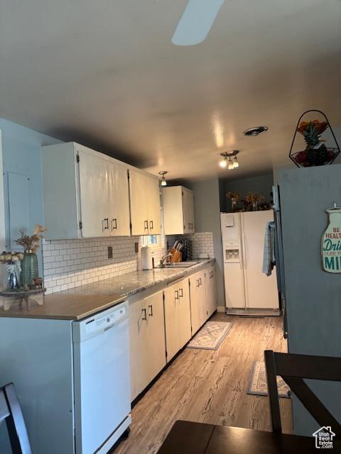 495 E 34 S Unit 10, Orem, UT 84097 - kitchen featuring white appliances, light wood finished floors, backsplash, a sink, and white cabinetry