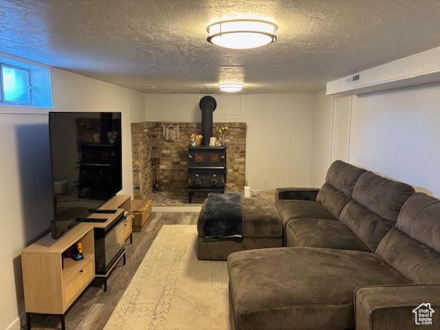 495 E 34 S Unit 10, Orem, UT 84097 - living area featuring wood finished floors, a textured ceiling, and a wood stove
