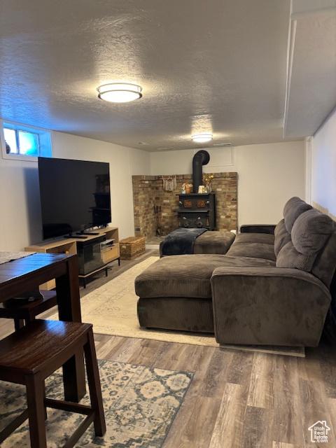 495 E 34 S Unit 10, Orem, UT 84097 - living area with wood finished floors, a wood stove, and a textured ceiling