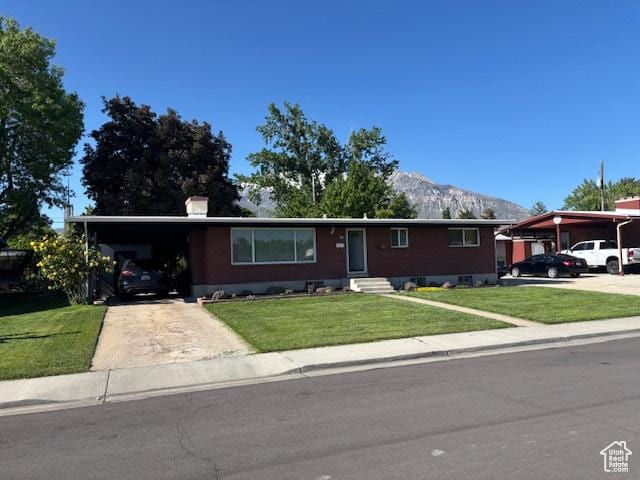 495 E 34 S Unit 10, Orem, UT 84097 - single story home with a mountain view, concrete driveway, a front yard, entry steps, and a carport