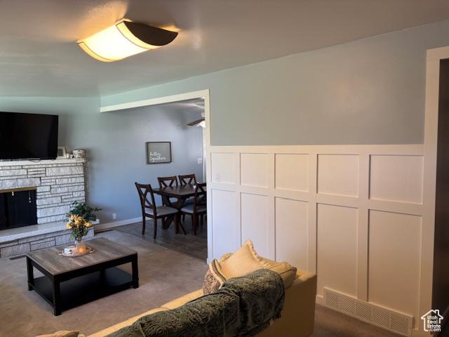 495 E 34 S Unit 10, Orem, UT 84097 - living area with wainscoting, a stone fireplace, and dark colored carpet