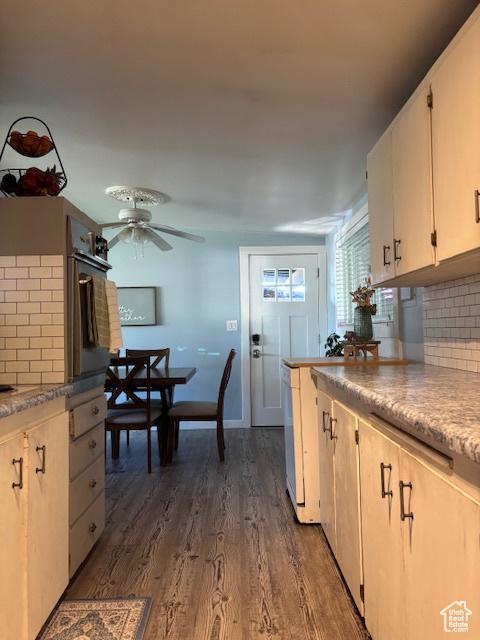 495 E 34 S Unit 10, Orem, UT 84097 - kitchen featuring decorative backsplash, ceiling fan, oven, dark wood finished floors, and light countertops