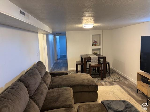 495 E 34 S Unit 10, Orem, UT 84097 - living area with wood finished floors, baseboards, and a textured ceiling