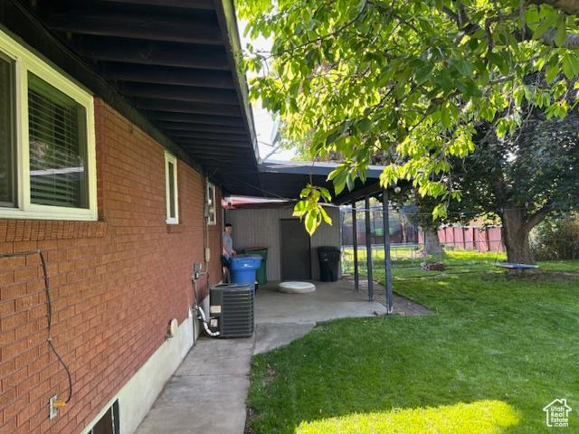 495 E 34 S Unit 10, Orem, UT 84097 - view of home's exterior with central air condition unit, brick siding, and a patio area
