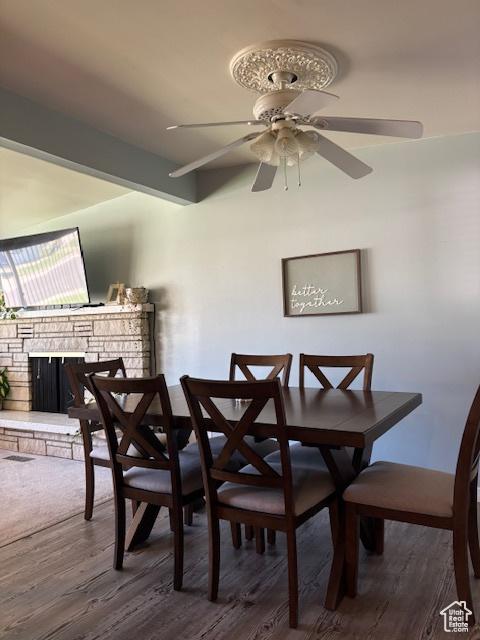 495 E 34 S Unit 10, Orem, UT 84097 - dining area with a ceiling fan, a stone fireplace, and wood finished floors