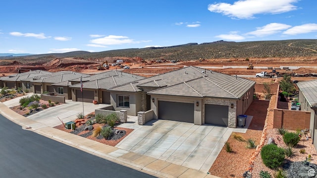 423 W Fitness Way, Ivins, UT 84738 - view of front of property with a garage, concrete driveway, a mountain view, and stucco siding