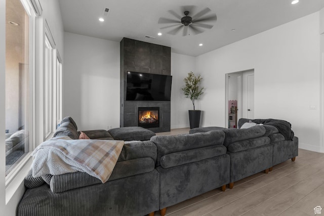 423 W Fitness Way, Ivins, UT 84738 - living area with light wood finished floors, a ceiling fan, a tiled fireplace, baseboards, and recessed lighting