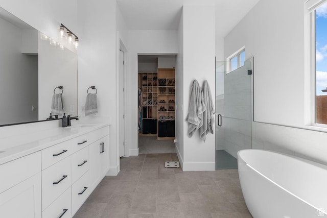 423 W Fitness Way, Ivins, UT 84738 - bathroom with double vanity, a freestanding bath, a stall shower, a walk in closet, and tile patterned floors