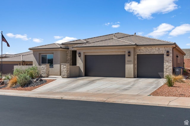 423 W Fitness Way, Ivins, UT 84738 - view of front of property featuring an attached garage, stucco siding, stone siding, driveway, and a tiled roof