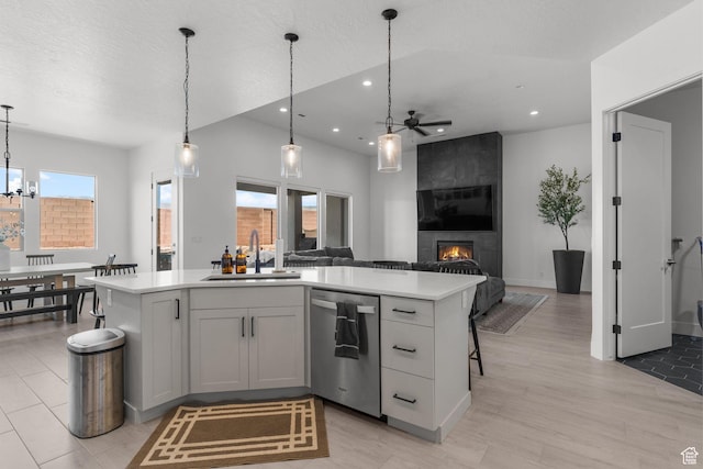 423 W Fitness Way, Ivins, UT 84738 - kitchen featuring dishwasher, a sink, ceiling fan, light countertops, and a large fireplace