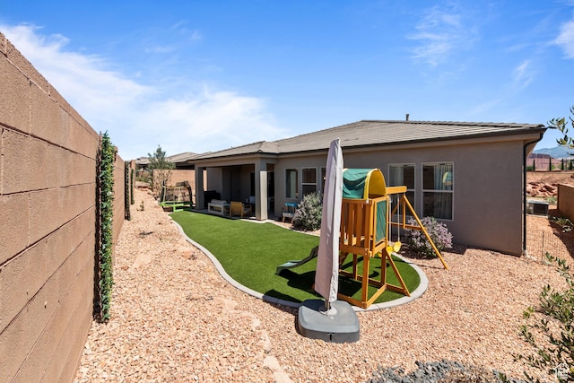 423 W Fitness Way, Ivins, UT 84738 - rear view of house with a playground and a fenced backyard