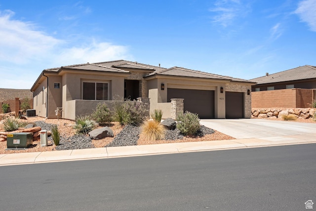 423 W Fitness Way, Ivins, UT 84738 - prairie-style home featuring a garage, driveway, stucco siding, and stone siding