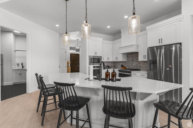 423 W Fitness Way, Ivins, UT 84738 - kitchen featuring stainless steel appliances, decorative backsplash, light countertops, white cabinets, and recessed lighting