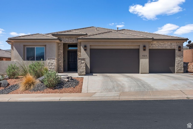 423 W Fitness Way, Ivins, UT 84738 - prairie-style home with stucco siding, stone siding, an attached garage, a tile roof, and driveway
