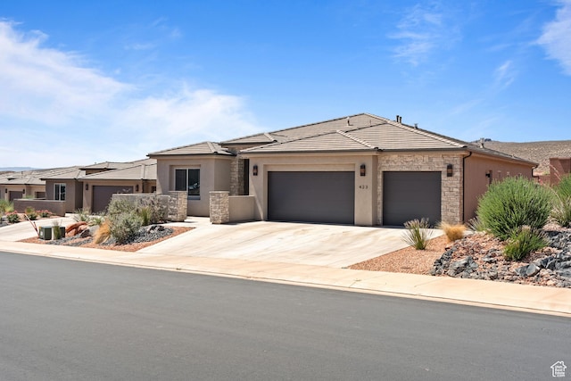 423 W Fitness Way, Ivins, UT 84738 - view of front of property featuring a garage, stone siding, stucco siding, and concrete driveway